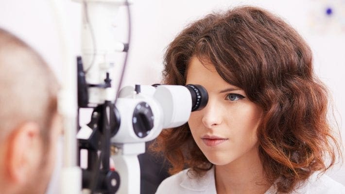 Optometrist performing visual field test