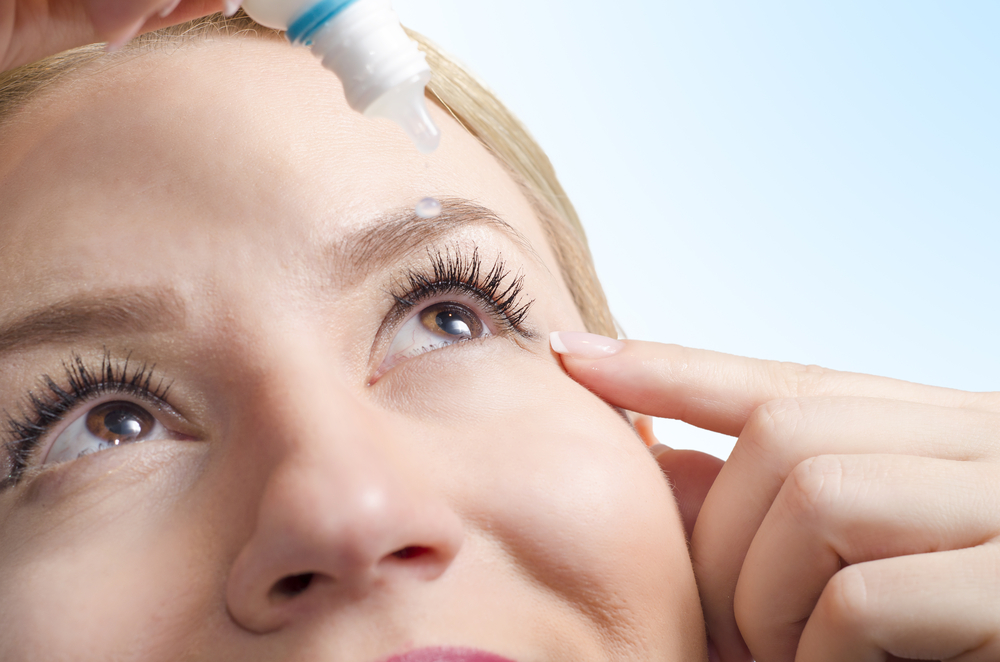 woman using eyedrops in lasik surgery recovery process