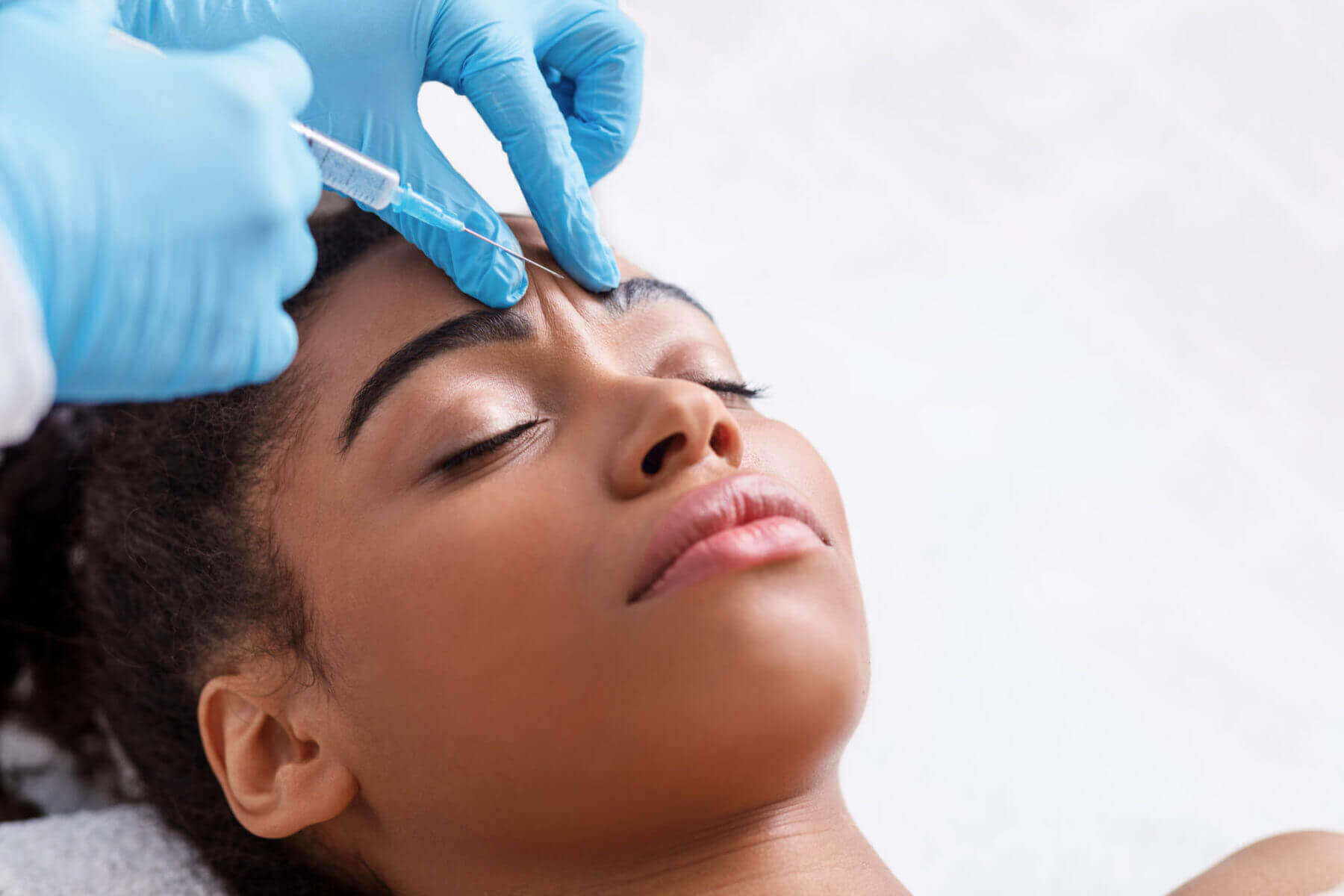 woman getting botox injections in forehead